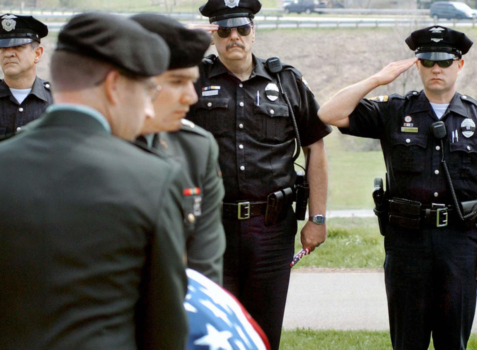 Second Place, News Picture Story - Daniel Melograna / The News JournalMansfield Police Officers Bruce Hughes, Randy Riggleman and Justin Duncan salutes as members of the 16th Calvary Division from Fort Knox, Ky., carry the body of A.J. Vandayburg to his grave, April 17, 2004, at Mansfield Cemetery. Vandayburg, who was in the 1st Infantry Division in the U.S. Army died from combat injuries on April 8, 2004, in Barez, Iraq. 