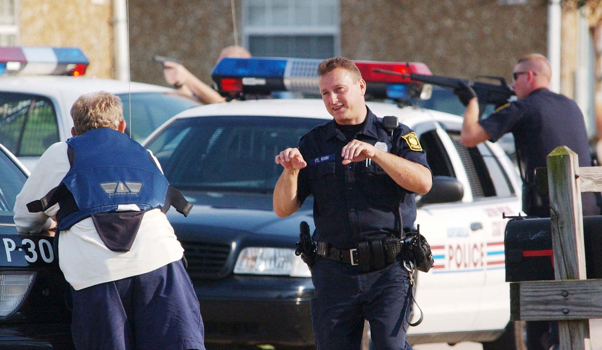 Award of Excellence, News Picture Story - Warren Dillaway / The Star BeaconJohn Koski, an Ashtabula police officer, gestures to the SWAT team while three policemen have their guns trained on an apartment where Paul Ganyard had barricaded himself. He wanted on a warrant and threatened that he would not be taken alive.
