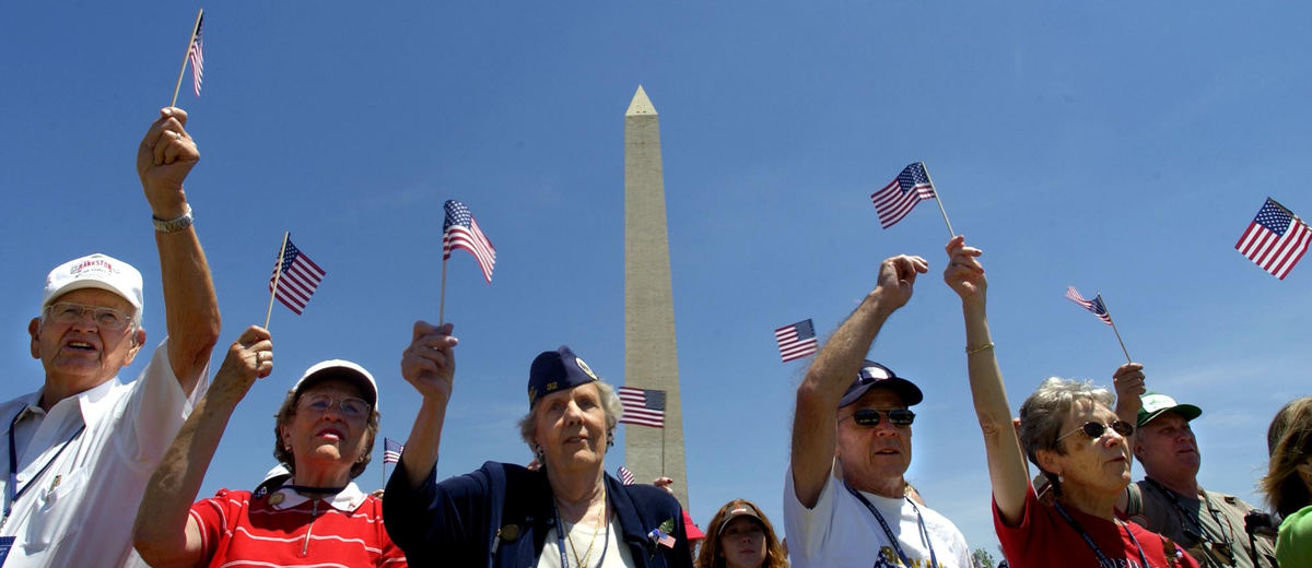 First Place, News Picture Story - Joshua Gunter / The Plain DealerVeterans, supporters, and spectators wave small flags to music during opening festivities of the World War II Memorial dedication, May 29, 2004 in Washington D.C.  