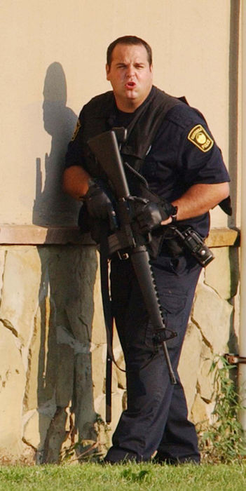 Award of Excellence, News Picture Story - Warren Dillaway / The Star BeaconTom Perry, an Ashtabula police officer, yells to another officer near a window where he was attempting to talk to Paul Ganyard who was refusing to surrender to an outstanding warrant.