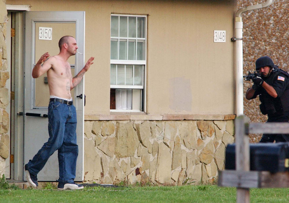 Award of Excellence, News Picture Story - Warren Dillaway / The Star BeaconTerry Tulino, of the Ashtabula County SWAT team, trains his gun on Paul Ganyard as he surrenders after a two hour standoff.