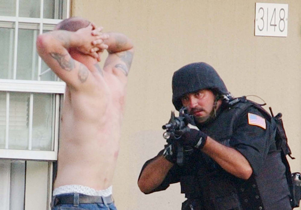 Award of Excellence, News Picture Story - Warren Dillaway / The Star BeaconTerry Tulino (right) of the Ashtabula County SWAT team trains his gun on Paul Ganyard after a two hour standoff that ended peacefully with Ganyard's surrender.