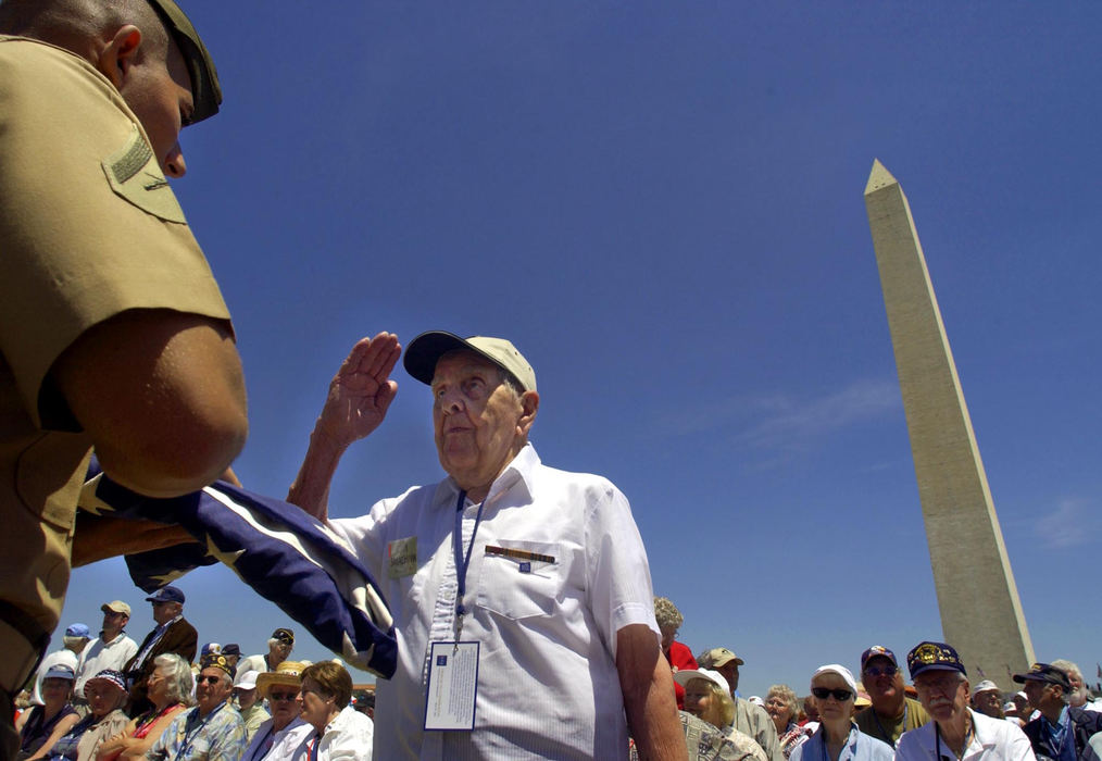 First Place, News Picture Story - Joshua Gunter / The Plain Dealer90-year-old John Sarachman, of Parma Heights, salutes Lance Cpl. Cedrik Pleasant, of Seattle, after handing back a flag he held during a ceremony honoring veterans at the World War II Memorial dedication, May 29, 2004 in Washington D.C. Dozens of vets lined up to hold Old Glory for the ceremony called Old Glory Travels America's Freedom Rd., a traveling tribute to vets. Sarachman served in the Air Force in Japan after becoming fluent in Japanese. 