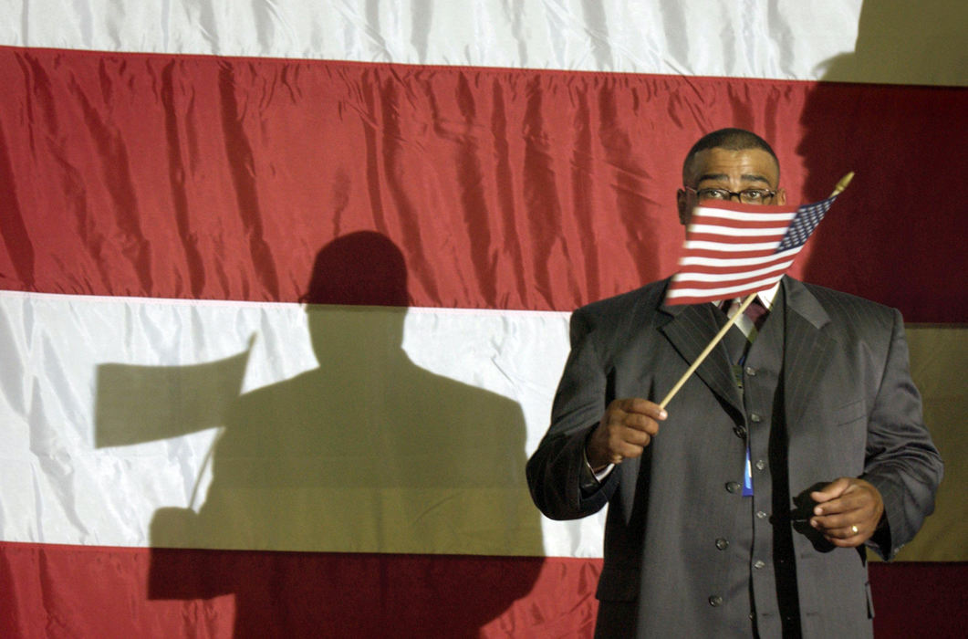 Second Place, James R. Gordon Ohio Understanding Award - ohn Kuntz, Mike Levy, Dale Omori, Chris Stephens, Lonnie Timmons III, Jeff Green and Bill Gugliotta / The Plain DealerFor Maragert Bernstein Story -- Evan Hannon of Massillon waves a flag while standing on the podium before the John Kerry Rally for Jobs at the Perry High School Gym in Massillon. June 25, 2004  (Lonnie Timmons III/Plain Dealer) Five Ohios