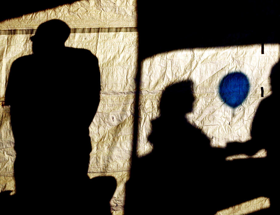 First Place, Pictorial - Greg Ruffing / Lorain Morning JournalThe late evening sun casts shadows of festival onlookers and a blue balloon onto the side of a tent during the Lorain International Festival.