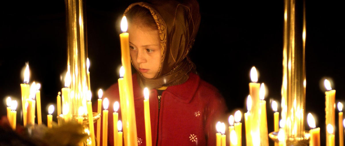 Third Place, Photographer of the Year - Joshua Gunter / The Plain DealerA young girl lights a prayer candle after viewing the Kursk Root Icon of Our Lady of the Sign that is on display at St. Sergius of Radonezh church, March 06, 2004 in Parma. 