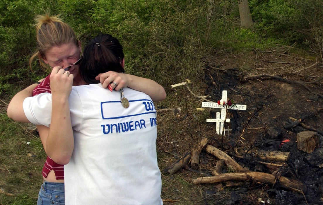 Third Place, Photographer of the Year - Joshua Gunter / The Plain Dealer16-year-olds Kelli Shead (left) and Jessica Smith, both sophomores at Medina Highland High School and friends of the two boys that died in a car accident, hug at the site of the crash, May 09, 2004 on State Rd. in Hinckley Township. The two, along with some other friends, spent more than an hour at the site cleaning up some of the debris left by the rescue teams and contributing to a memorial.