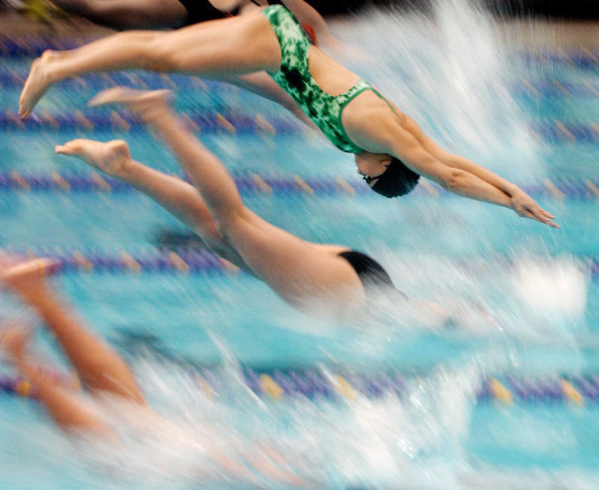 First Place, Photographer of the Year - John Kuntz / The Plain DealerNichole Gatlin from Bedford High School launches high in the air for the start of the 5th heat in the girls 50 yard freestyle event during the Lake Erie League swimming and diving championships January 31, 2004 hosted by Lakewood High School.