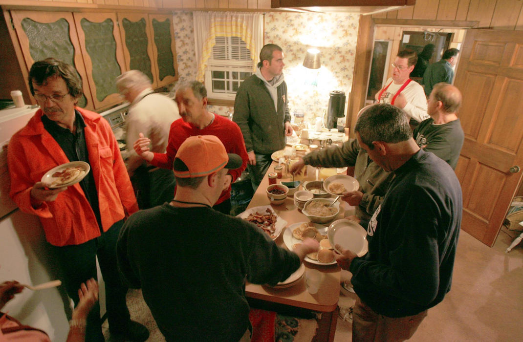 Third Place, Photographer of the Year - Joshua Gunter / The Plain DealerHunters awake to a feast of a breakfast at It's Home Bed and Breakfast, owned by Madonna and Butch Gemus, October 29, 2004  on Pelee Island in Ontario Canada. The group of hunters have developed a close relationship with the owners, bringing them gifts each season and sending them Christmas cards. Each meal is made from scratch by the owners.   