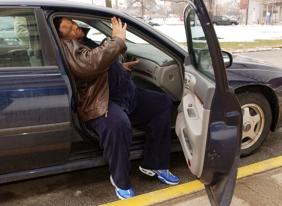 First Place, Photographer of the Year - John Kuntz / The Plain DealerChip Fleshman struggles to get into his car because of his size as they leave for the hospital to get the bariatric surgery. 