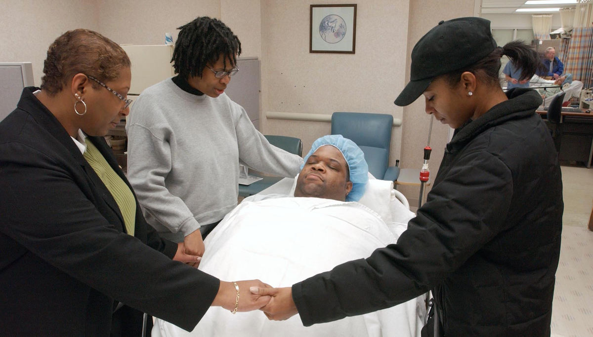 First Place, Photographer of the Year - John Kuntz / The Plain DealerChip is prayed for by his wife Tony and Tony's sister Tia (R) and mother Lynn before his bariatric surgery at St. Vincent Charity Hospital.