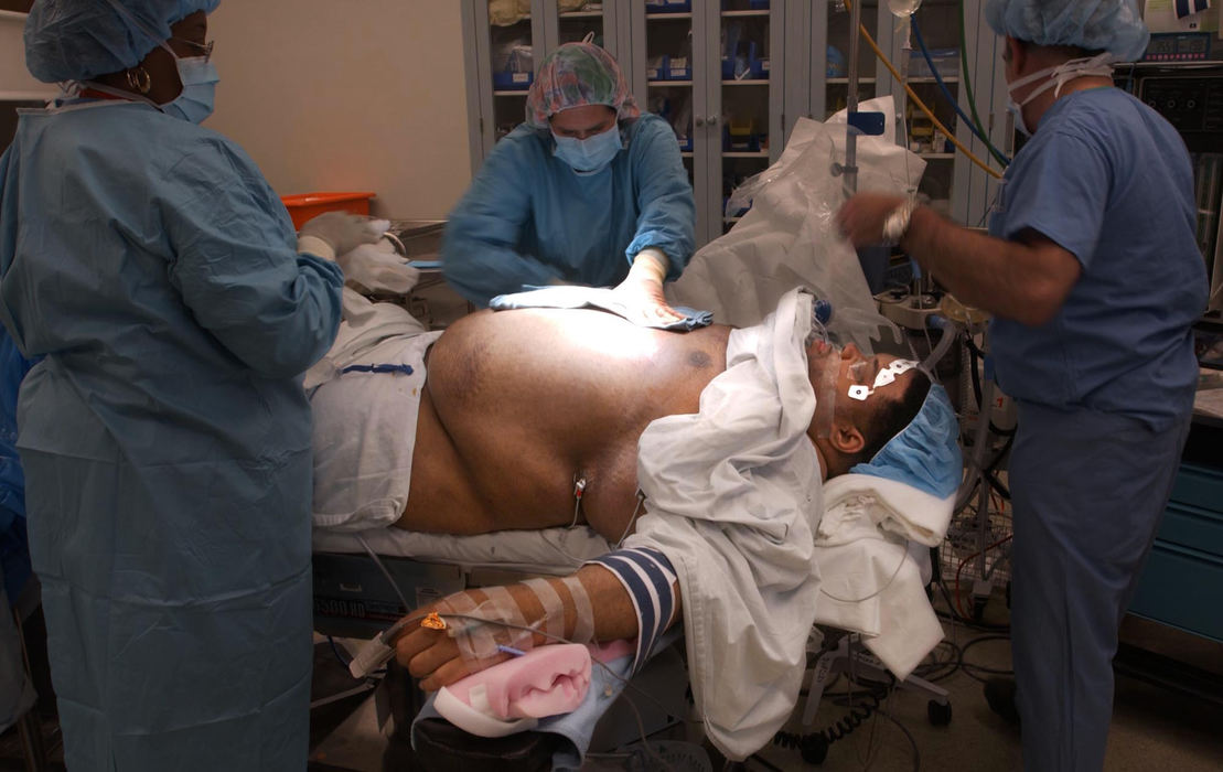 First Place, Photographer of the Year - John Kuntz / The Plain DealerChip is lit by the surgical light in preparation for his surgery as operating room nurses and technicians ready the room.