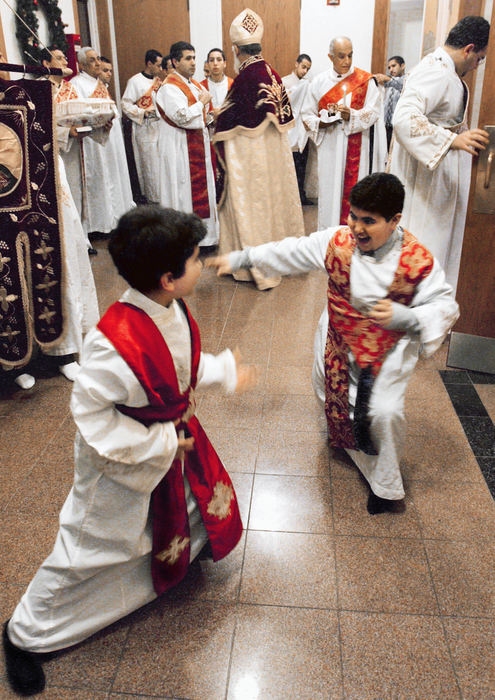 First Place, Photographer of the Year - John Kuntz / The Plain DealerAnthony Abanoub Salama, 9, a deacon at St. Mark Coptic Orthodox Church in Seven Hills enjoys some mock martial arts moves with fellow deacon before the Holy Nativity Divine Liturgy service January 6, 2004. 