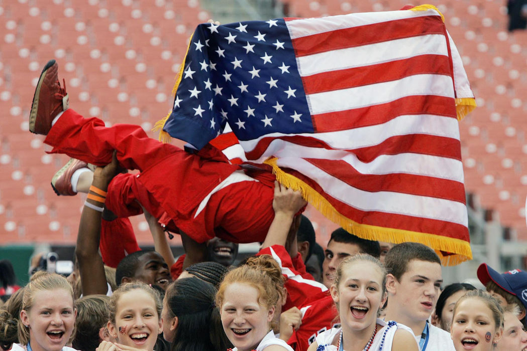 First Place, Photographer of the Year - John Kuntz / The Plain DealerThe United States team lifts up one of the to hold up the US flag before as President George W. Bush made his way out to talk with the International Children's Games participants in Cleveland July 30, 2004 at Cleveland Browns Stadium.   International Children's Games hoist one of their teammates to display the American flag Friday at Cleveland Browns Stadium just before the appearance of President Bush.