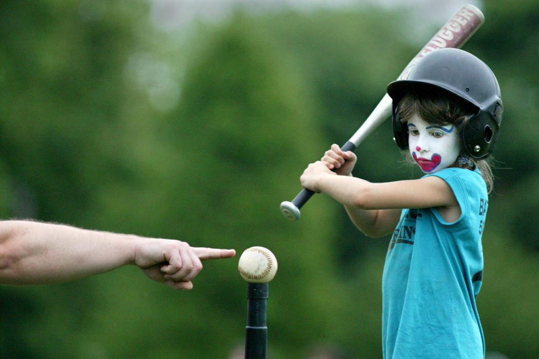 Award of Excellence, Photographer of the Year - Fred Squillante / The Columbus DispatchBrenna O'Sullivan, 7, gets some batting pointers from head coach Temsen O'Neill  before her next at bat during a game against the Reds at Whetstone Park in Columbus. Brenna, who plays for the Marlins, came to the game after a trip to a Wendy's restaurant where it was family night and there was face painting, said her mom, Melissa O'Sullivan.The teams play in the North Columbus Intramural League. 