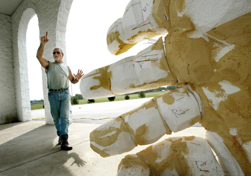 Award of Excellence, Photographer of the Year - Fred Squillante / The Columbus DispatchSculptor James Lynch stands before the right hand that he will place on his 60-foot tall sculpture of Jesus that is under construction at the Solid Rock Church in Monroe. Lynch, who is creating the piece from a plan by designer Brad Coriell, has previously sculpted works for casinos in Las Vegas. Solid Rock pastor Darlene Bishop said, in reaction to controversy about the sculpture, "At exit 29 there are two 50-foot-high signs for a strip show, and nobody says anything about that."