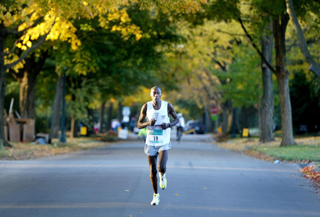 Award of Excellence, Photographer of the Year - Fred Squillante / The Columbus DispatchOn his way to winning the Columbus Marathon, Eliud Kering runs through Bexley alone. Kering, of Kenya, finished the race in 2:18:39.