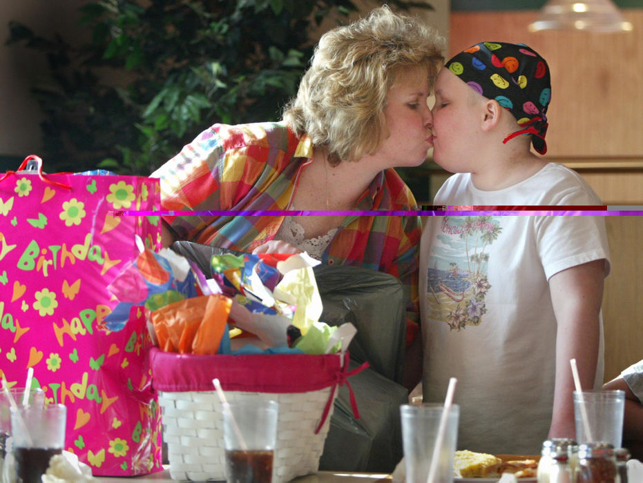 Award of Excellence, Photographer of the Year - Fred Squillante / The Columbus DispatchAbbie gets a kiss from her mom, Sherrie, as they pack up Abbie's birthday gifts  after her party at Godfather's Pizza in Marion. Abbie turned 11. 