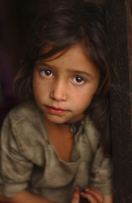 Award of Excellence, Portrait/Personality - Garrett Hubbard / Brooks InstituteThe eldest daughter of an armless, yet prideful Brahman father stands at the door to their house in the Pujalti Village near Mussoorie, India.  This family lives in utter poverty, but because they are Brahman, the highest caste in a culture that defines worth by ones caste, they are respected and proud of their life.