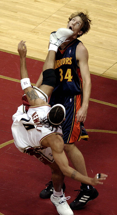 Second Place, Sports Action - Roadell Hickman / The Plain DealerIra Newble of the Cavaliers attempts to put a shot up over Golden State's Mike Dunleavy during the 1st period. Newble was fouled on the play.