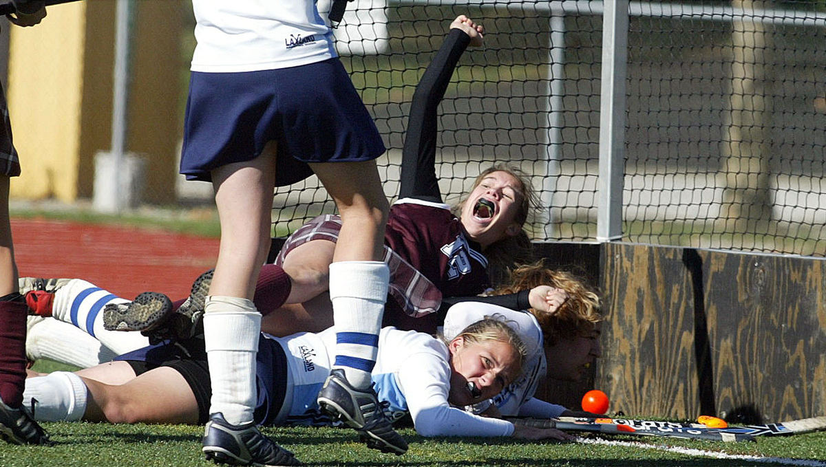 Award of Excellence, Sports Action - Kim Riesbeck / ThisWeek NewspapersColumbus Academy's Erin Wolf rejoices after scoring the only goal in the state championship game at Upper Arlington. Underneath her are Mount Notre Dame's Marie Huth and Danielle Suarez.  