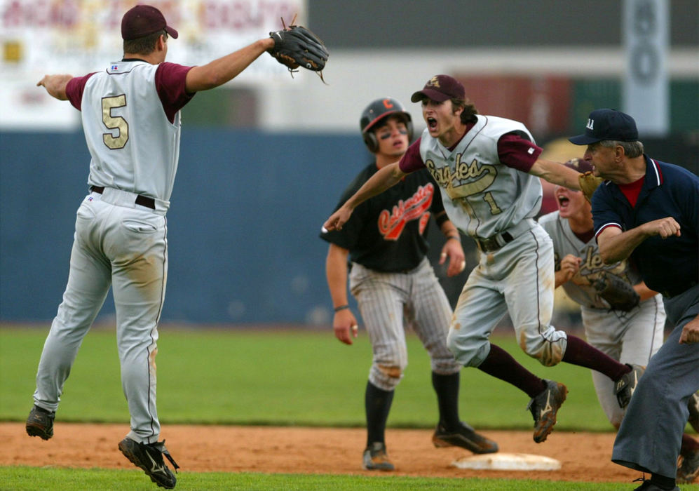 First Place, Sports Feature - Lorrie Cecil / ThisWeek NewspapersNew Albany's Gentry Zacheis (left)  Ben Jeffers, and Kevin Corica begin to celebrate as the umpire calls Coldwater's Dusty Ahrens out for the final out  in the Division III state championship game at Thurman Munson Memorial Stadium in Canton.  New Albany won 5-4 to become the state champions for the first time in school history.  