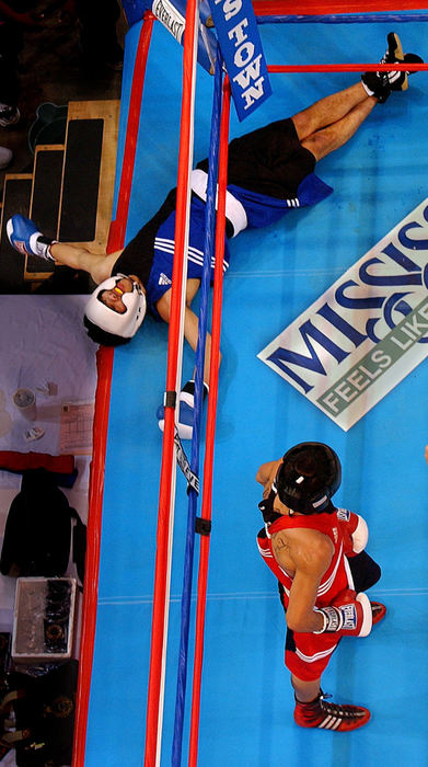 Second Place, Sports Feature - Mike Levy / The Plain DealerOlympic boxing hopeful Miguel Gonzalez lies flat on his back after being knocked down by Victor Ortiz at the 2004  Olympic team trials-boxing in Tunica, MS.  