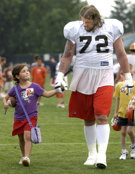 Award of Excellence, Sports Feature - Bob Rossiter / The RepositoryGrace Bolger 7, and Ryan Tucker walk off the Browns practice field in Berea. Following practice team members were matched with buddies to carry their helmet or just hang out with them on the way off the field.