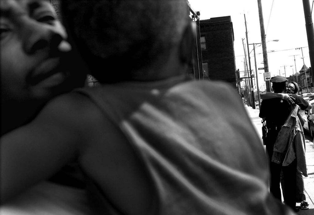 First Place, Spot News over 100,000 - Dale Omori / The Plain DealerTwo-year-old Jermel Griffith rests in arms of his dad, Greg Potter, at the scene on E. 105th in Cleveland as his grandmother gives a hug of thanks to a Cleveland police officer.  The car Jermel was riding in was taken by his 14-year-old cousin.  Police issued an Amber alert in search of the two kids and the car.  Police stopped the car and arrested the cousin and reunited Jermel with his family.