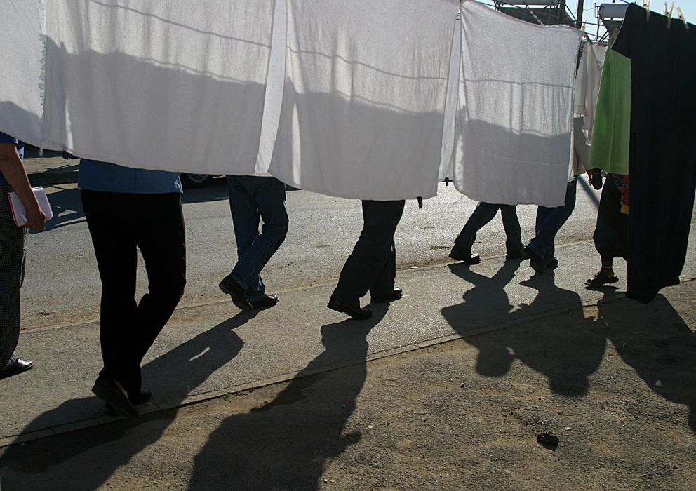 First Place, Student Photographer of the Year - Samantha Reinders / Ohio UniversityThe Crushing Pride Factor - Tourists on the Grassroots “Freedom Tour” walk around Khayalitsha Township weaving in and out of the community’s clean laundry. 