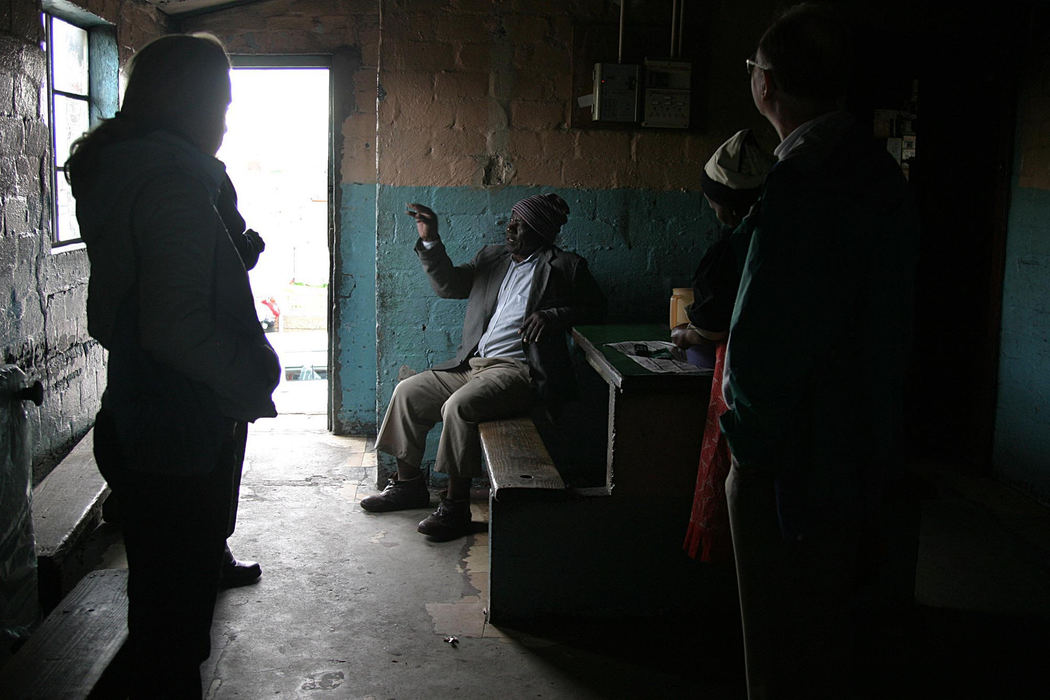First Place, Student Photographer of the Year - Samantha Reinders / Ohio UniversityThe Sharing Factor - An elderly hostel dweller enthralls a 'Rainbow Tours' tour group with stories of life in the hostels during the Apartheid regime in South Africa.