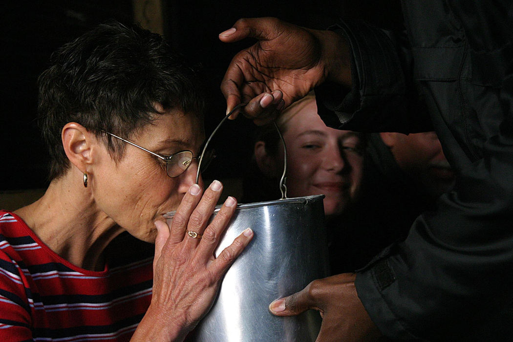 First Place, Student Photographer of the Year - Samantha Reinders / Ohio UniversityThe Interaction Factor - Cherie Althauser (British) cautiously takes a sip from a rusty can full of ‘Umqomboti’ (traditional sorghum beer) in a local ‘shebeen’ (informal tavern) while her daughter, Cassie, looks on. Township tours have been criticized in the South African media for being too much like patronizing safari-style events –where tourists merely stay on their buses, observing the townships from its windows. Many tour operators have added the shebeen visit to their tour itinerary to enable tourists to meet and interact with locals. 