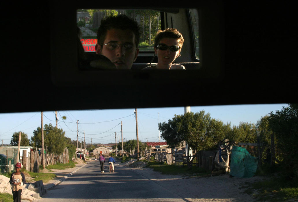 First Place, Student Photographer of the Year - Samantha Reinders / Ohio UniversityThe Reality Factor - Maggie and Jan Dijkstra (Dutch) look through the rearview mirror as they leave Khayalitsha Township. Having just witnessed the absurd conditions that more than fifty percent of Cape Town's population live under, the couple head back to the five star hotel where they will be staying. When this couple looks back at their experience in a South African township will they see it as a day trip to a real live theme park – or as the reality of someone else’s life?