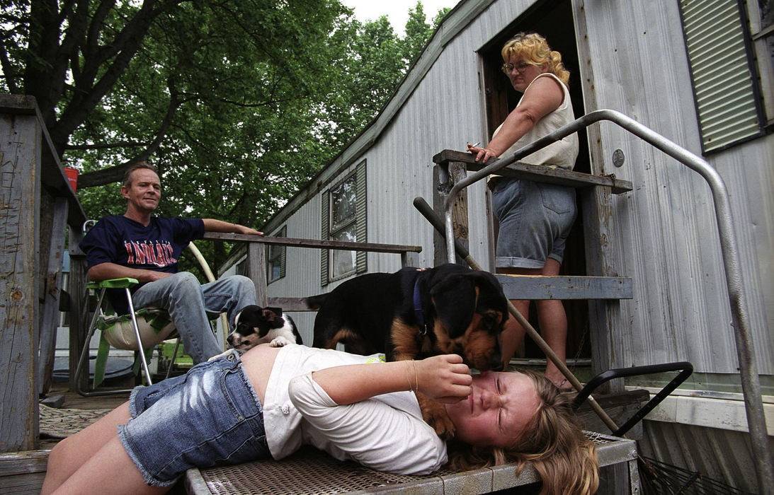 First Place, Student Photographer of the Year - Samantha Reinders / Ohio UniversityIt is a weekday afternoon and Christine’s jobless mother and stepfather look on as George – a stray dog that has made his home with the family – attacks her with licks. 