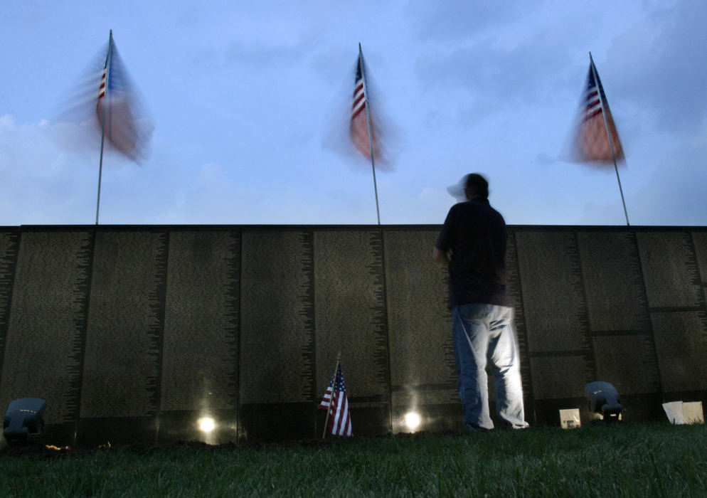 Second Place, Student Photographer of the Year - Michael P. King / Ohio University"This is what I can do for the people I know who are on the wall," says volunteer Charles Kennedy, shown standing watch over the Moving Wall-The Vietnam Wall Experience, a 252-foot traveling replica of the Washington, D.C. monument, at Kingswood Memorial Park north of Columbus, August 27, 2004. Kennedy, a veteran from Lithopolis, who served in the U.S. Army 25th Infantry Division in Vietnam from December 1967 - December 1968, has volunteered two other times in past years when the wall has come to Ohio.
