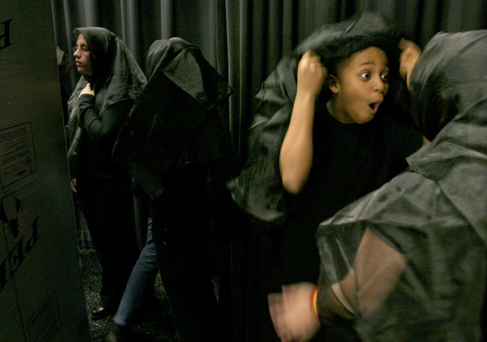 Second Place, Student Photographer of the Year - Michael P. King / Ohio UniversitySixth-grade chorus-members Myeisha Scott (facing) and Morgan Rako (right) joke-around backstage during a practice for New Albany Middle School's production of "Fools", December 1, 2004. Also waiting to go on stage is sixth-grade chorus member Amanda Poll.