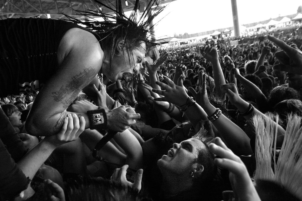 Second Place, Student Photographer of the Year - Michael P. King / Ohio UniversityJorge, the one-named lead singer of The Casualties, takes a ride over fans while performing as part of the Vans Warped Tour at Germain Amphitheater in Columbus, on August 17, 2004. Singing-along with the musician is rock fan Jared Siculan of Columbus.