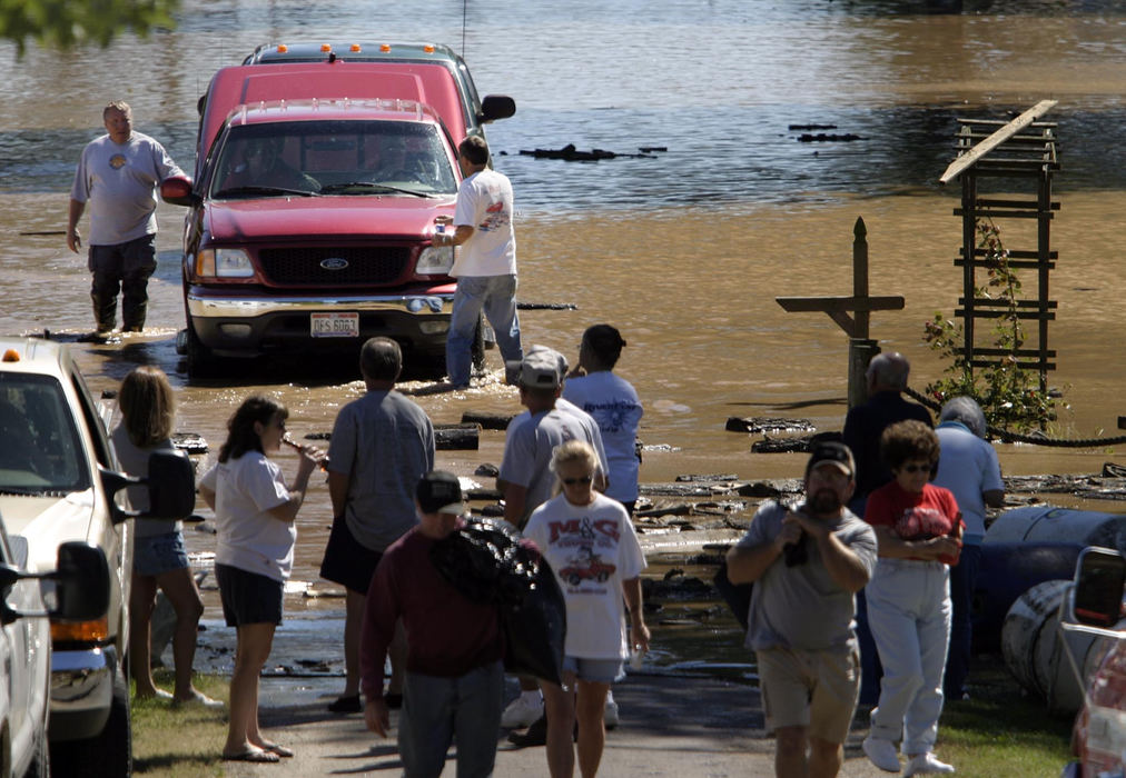 Second Place, Student Photographer of the Year - Michael P. King / Ohio UniversityHockingport, Ohio was once a major port city along the Ohio River. Today, it is more of a township, consisting of campers, trailers and mobile homes occupying the riverfront. Hockingport residents make last minute attempts to salvage vehicles, trailers, and personal effects at the bottom of Grand Street on September 18, 2004. The cresting of the Hocking and Ohio Rivers left some people in Hockingport with more than five feet of water inside their homes and businesses.