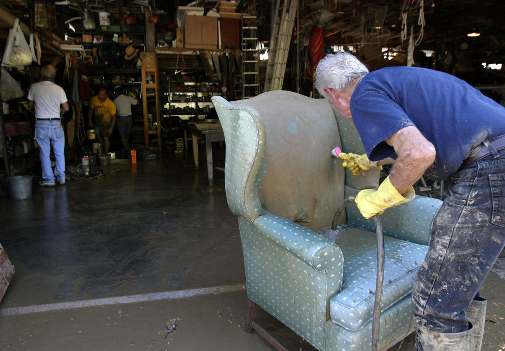 Second Place, Student Photographer of the Year - Michael P. King / Ohio UniversityHockingport resident Bob Martin attempts to salvage his upholstered armchair outside his poll barn on September 23, 2004. Martin, a builder by trade, sustained damages to vehicles, tools and supplies in the barn - anything lower than 5 feet off the ground.