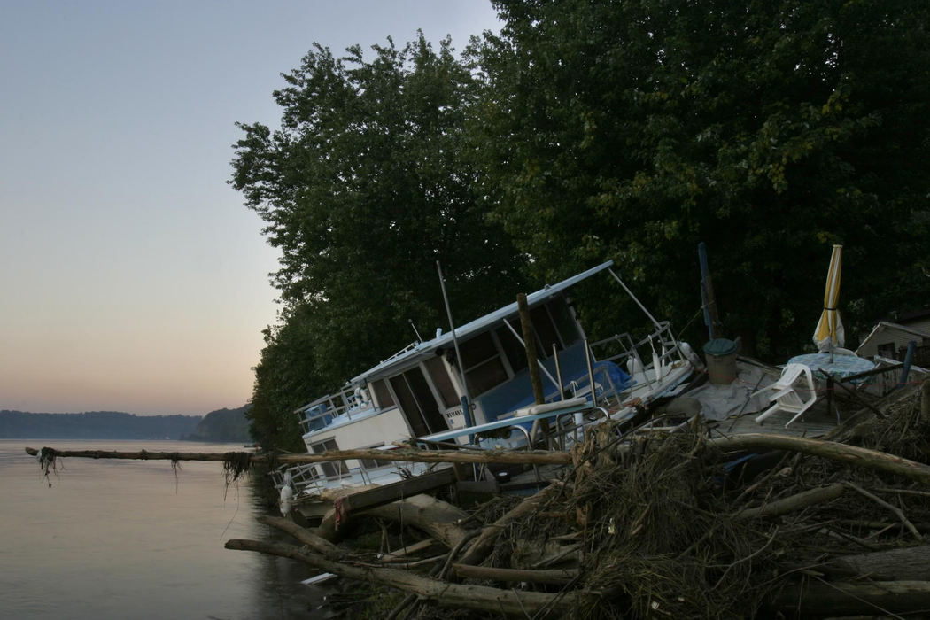 Second Place, Student Photographer of the Year - Michael P. King / Ohio UniversityAfter floodwaters receded, a houseboat and debris sat washed-up along the banks of the Ohio River along State Route OH-124 just outside of Hockingport, September 22, 2004.