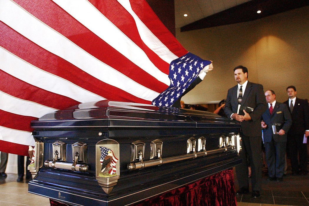 Third Place, Student Photographer of the Year - Haraz Ghanbari / Kent State UniversityFamily and friends of Birmingham, Ala., Police Officer Carlos Winston Owen pause for a moment as an American Flag is draped over his coffin after a funeral service, June 21, 2004, in Argo, Ala. Owen was one of three police officers killed June 17 while attempting to deliver a search warrant.