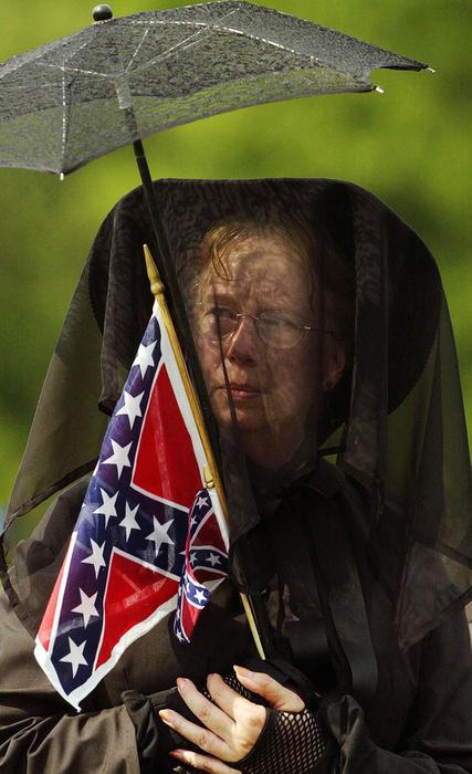 Third Place, Student Photographer of the Year - Haraz Ghanbari / Kent State UniversityA mourner holds a Confederate flag as she waits in line to pay respect to Alberta Martin, June 12, 2004 in Curtis, Ala. Martin, the last widow of a Civil War veteran, died May 31.