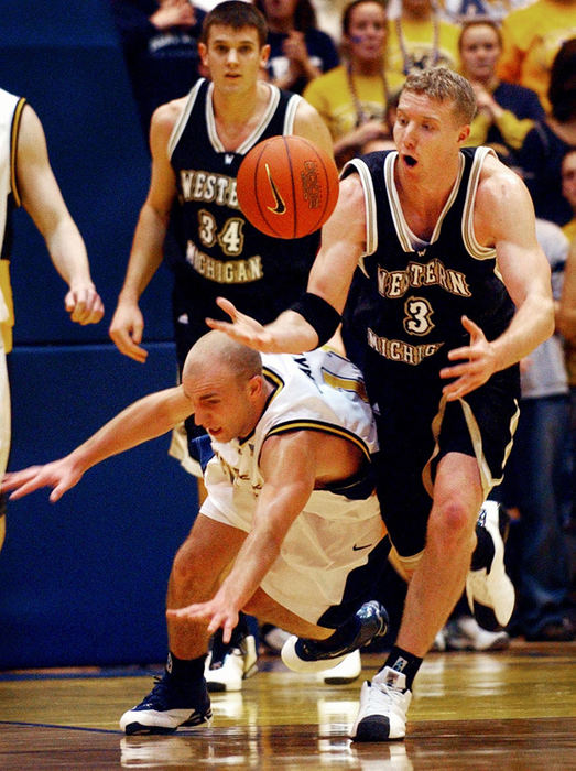 Third Place, Student Photographer of the Year - Haraz Ghanbari / Kent State UniversityWestern Michigan's Brian Snider, (33), tries to take control of the ball as Kent State University's Matt Jakeway, braces for a fall during the during the first period of play, Jan. 21, 2004 at Kent State University. Kent State beat Western Michigan 84-71. 
