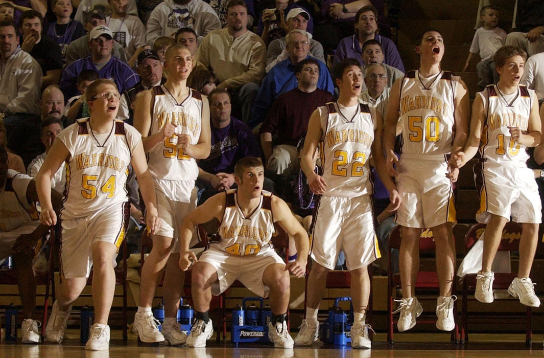 Third Place, Student Photographer of the Year - Haraz Ghanbari / Kent State UniversityMembers of the Walsh Jesuit High School basketball team jump to their feet as their teammate attempts a shot at the buzzer March 11, 2004 in Stow. Walsh Jesuit beat Keystone, 77-73 in double overtime. 