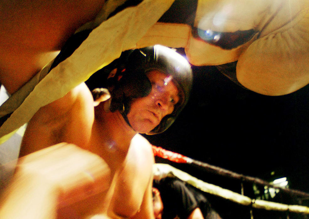 Third Place, Student Photographer of the Year - Haraz Ghanbari / Kent State UniversitySemi-truck driver Andy Lundy, 29, of Mobile, Ala., takes a break between rounds of the Toughman Contest, July 9, 2004, in Dothan, Ala. The contest requires participants train for a minimum of 30 days, compete within their weight division, pass a pre-fight medical physical and be examined after their fight.