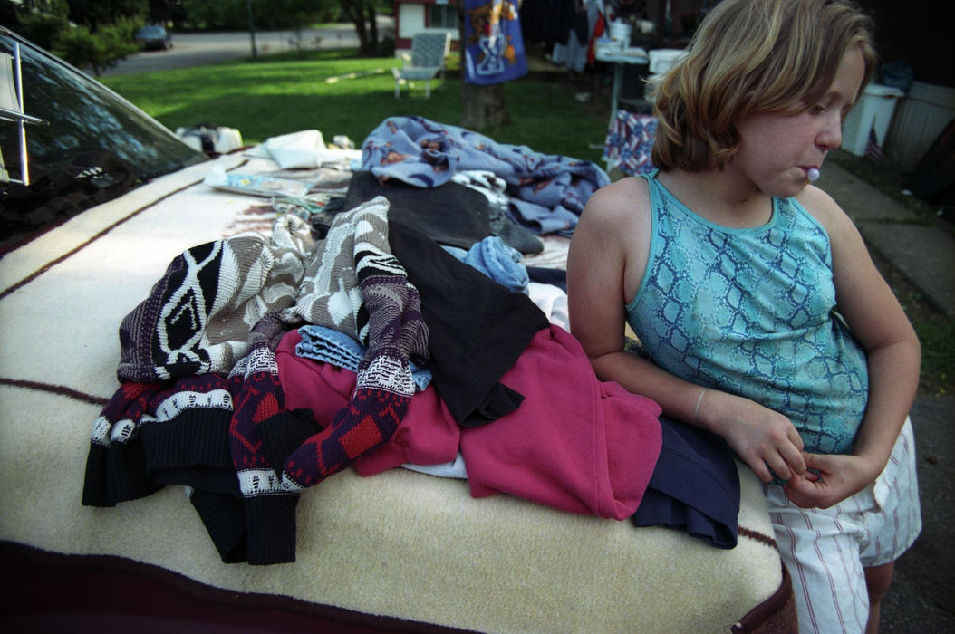 First Place, Student Photographer of the Year - Samantha Reinders / Ohio UniversityChristina man's a friends yard sale. In return she can pick out anything she would like.  