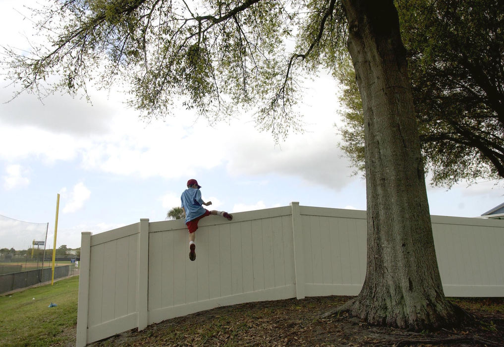 Third Place, Sports Picture Story - Chuck Crow / The Plain DealerThe quest goes on, as a youngster climbs a fence that flies over from batting practice, first one to the ball gets the souvenir.  A game that can be played with a crowd or all by your self.