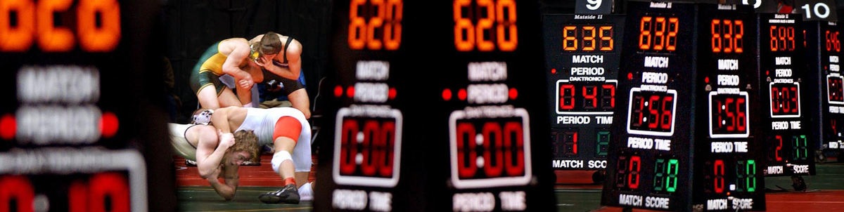 First Place, Sports Picture Story - John Kuntz / The Plain DealerA pair of Division I wrestling matches continue on two of the ten mats and scoreboards used to whittle the competitors down to the final championship round, February 27, 2004 during the 67th OHSAA state wrestling championships in Columbus.