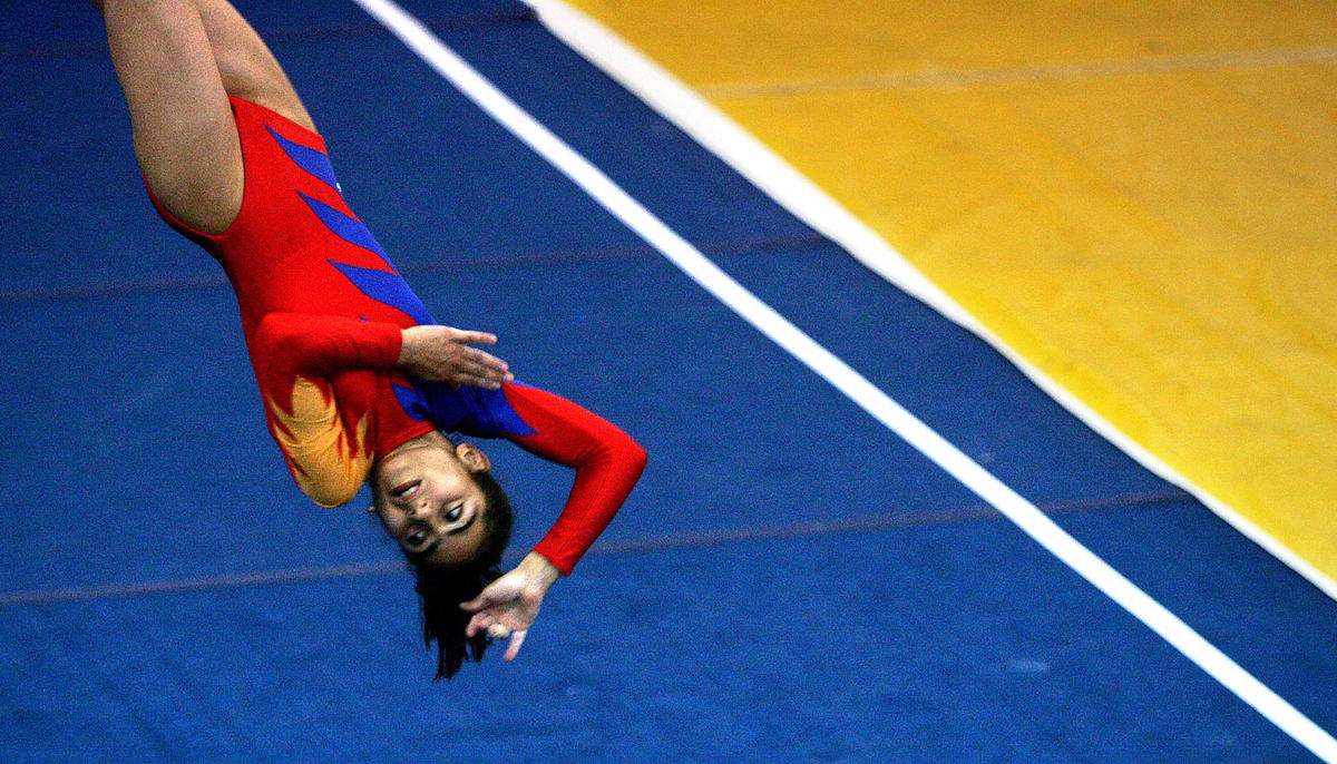 Second Place, Team Picture Story - Mike Levy / The Plain DealerLiana Kobalian of Armenia competes in a gymnastics floor exercise at John Carroll University in University Heights. 