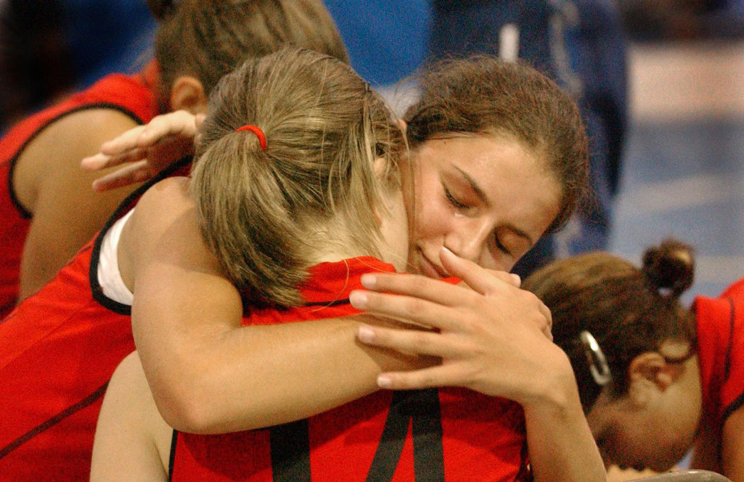 Second Place, Team Picture Story - Lynn Ischay / The Plain DealerAna Skarlovnik gives Mojca Rozenicnik (back to camera) a comforting hug after Rozenicnik hurt her ankle in the gold medal competition volleyball game.  